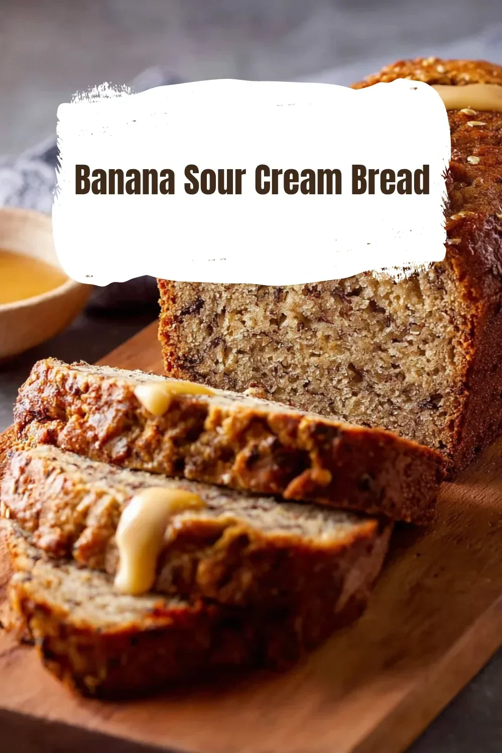 A slice of moist banana sour cream bread on a wooden cutting board