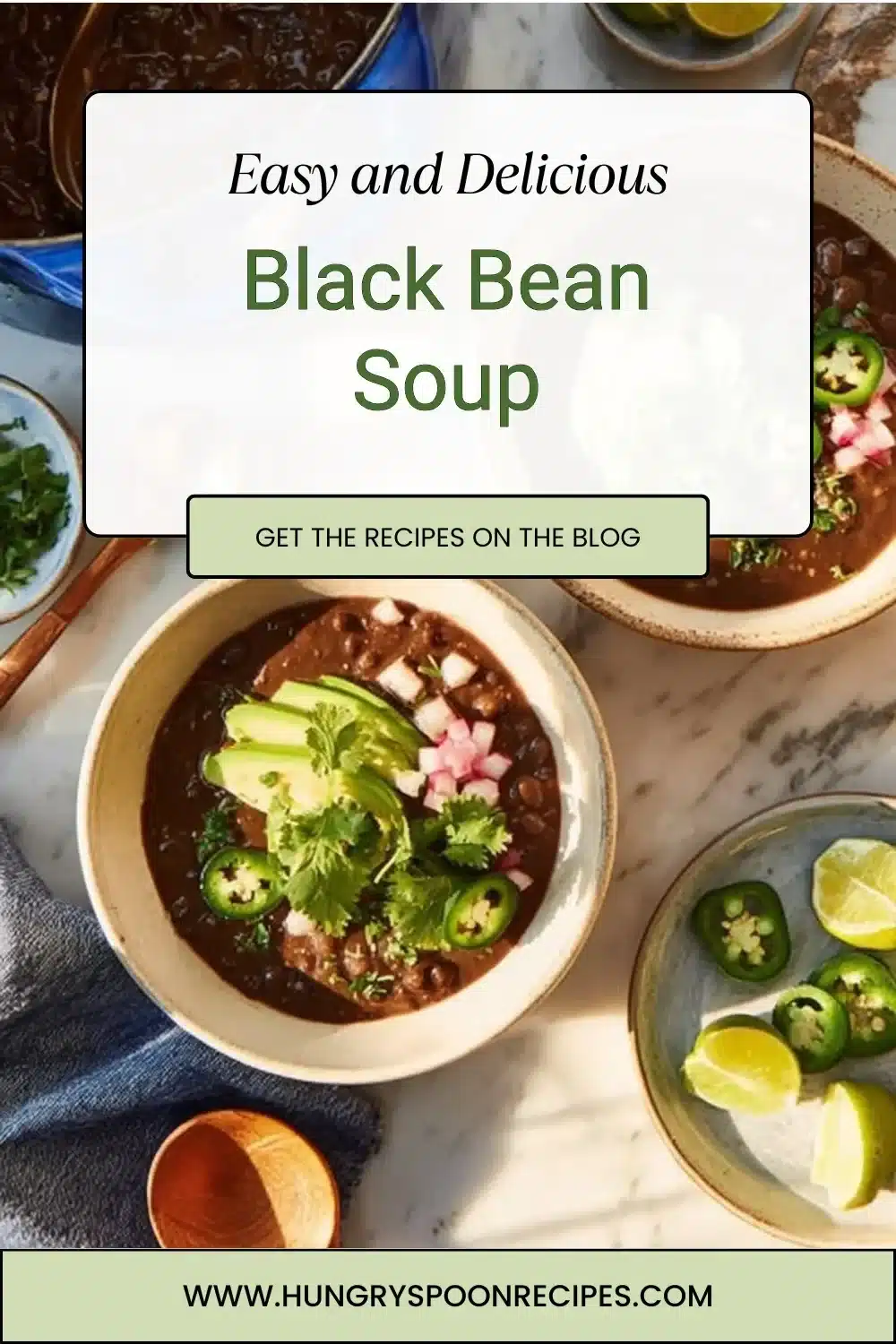 A steaming bowl of homemade black bean soup garnished with cilantro and lime.
