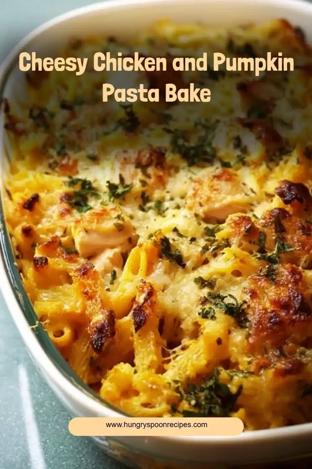 Cheesy Chicken and Pumpkin Pasta Bake 1 Cheesy chicken and pumpkin pasta bake served in a casserole dish