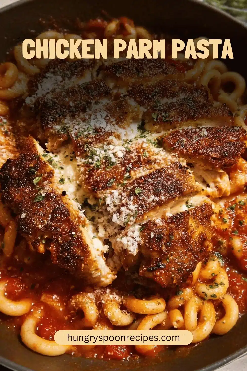 Chicken Parm Pasta 1 A delicious serving of Chicken Parm Pasta topped with cheese and fresh herbs