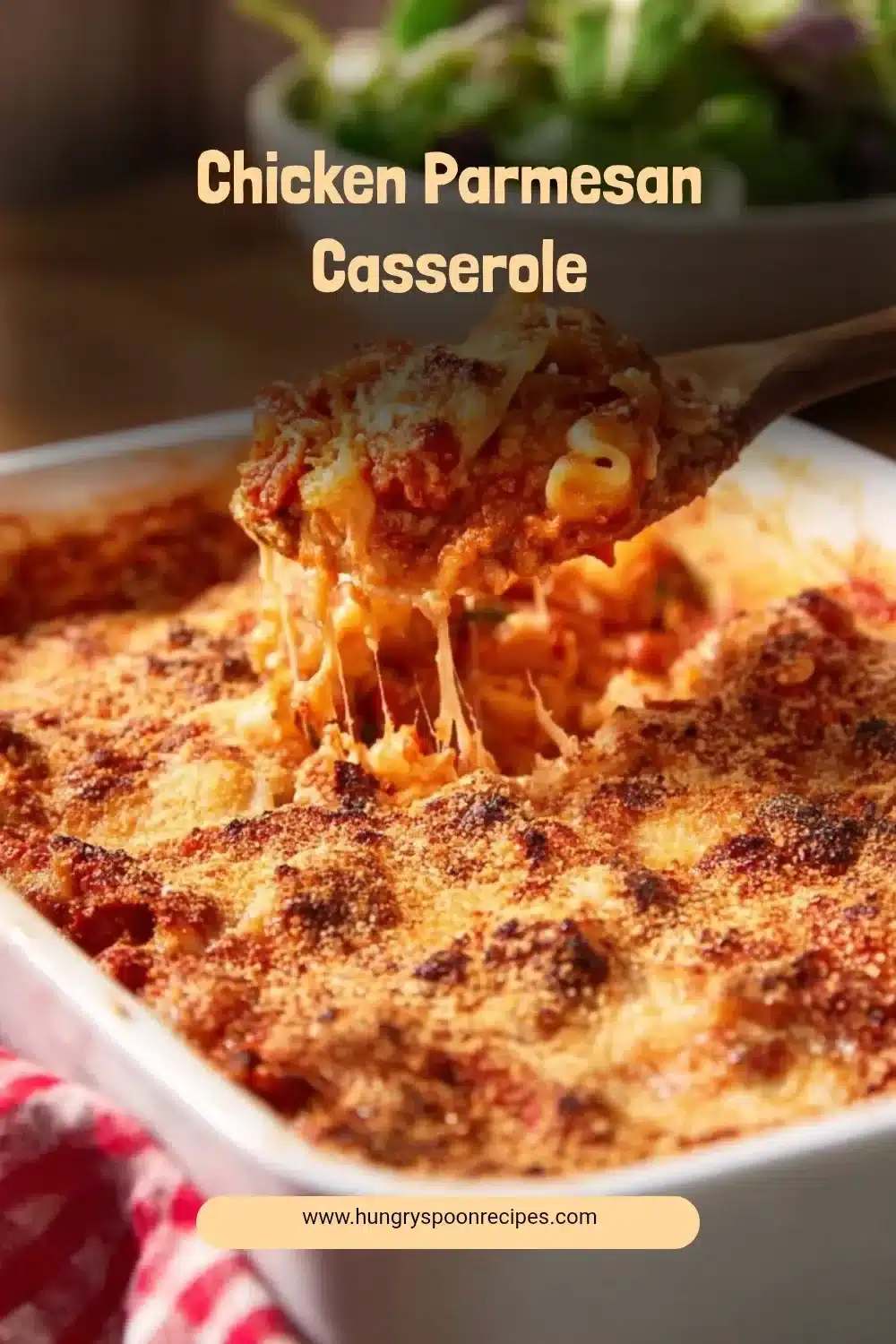 Baked Chicken Parmesan Casserole topped with cheese and fresh herbs