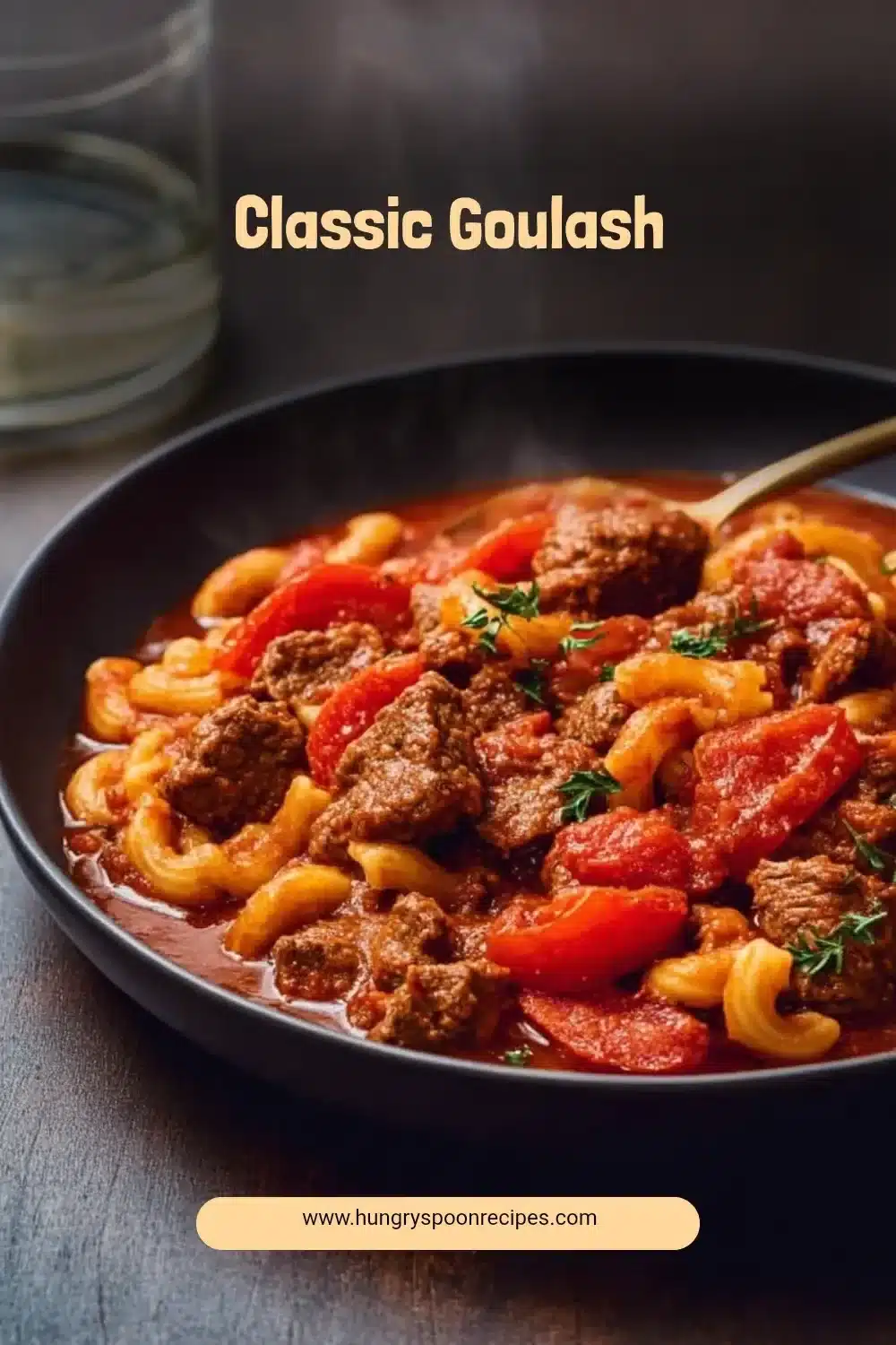 Classic Goulash 1 A bowl of Classic Goulash topped with herbs, showcasing hearty ingredients.