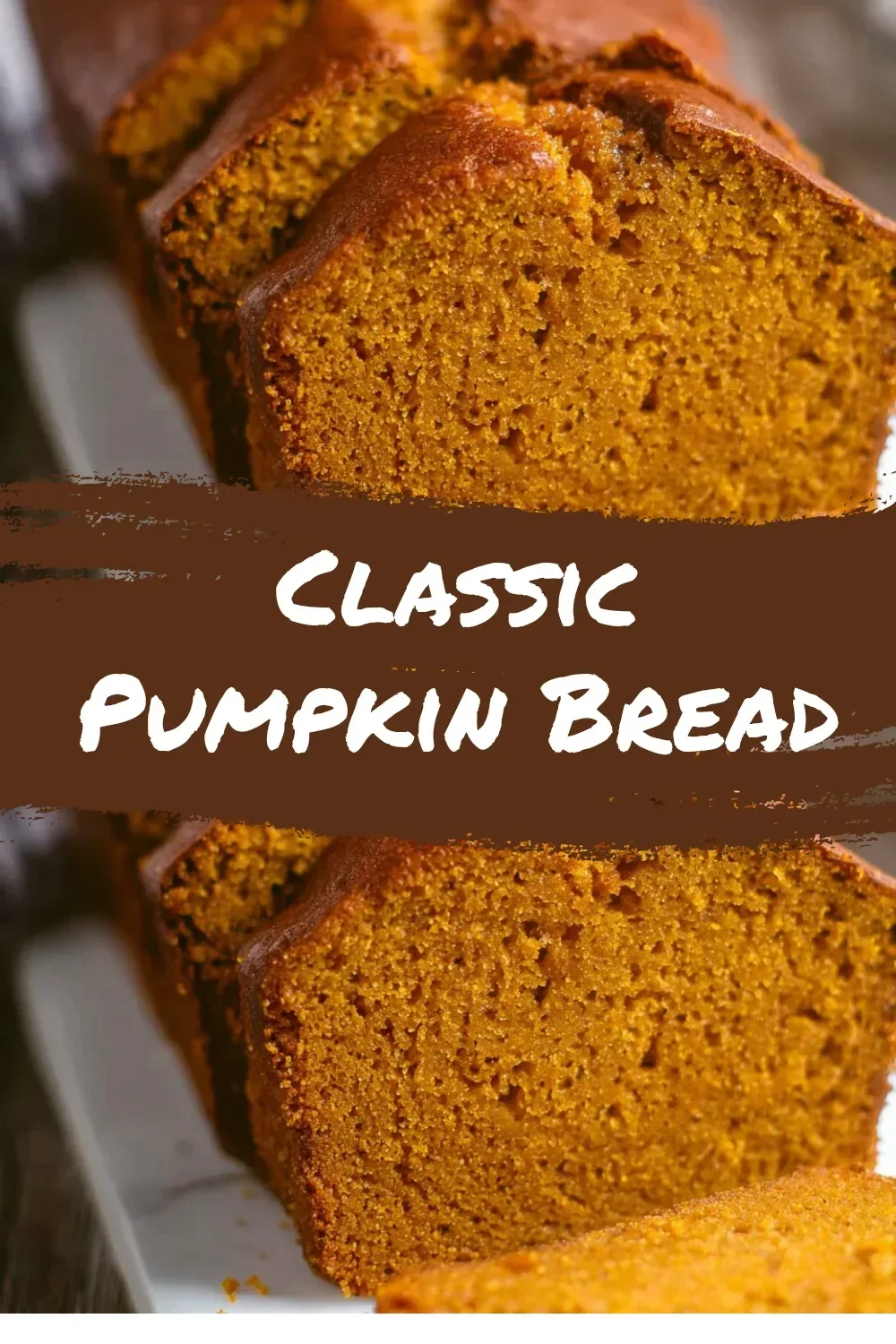 Freshly baked classic pumpkin bread on a wooden table
