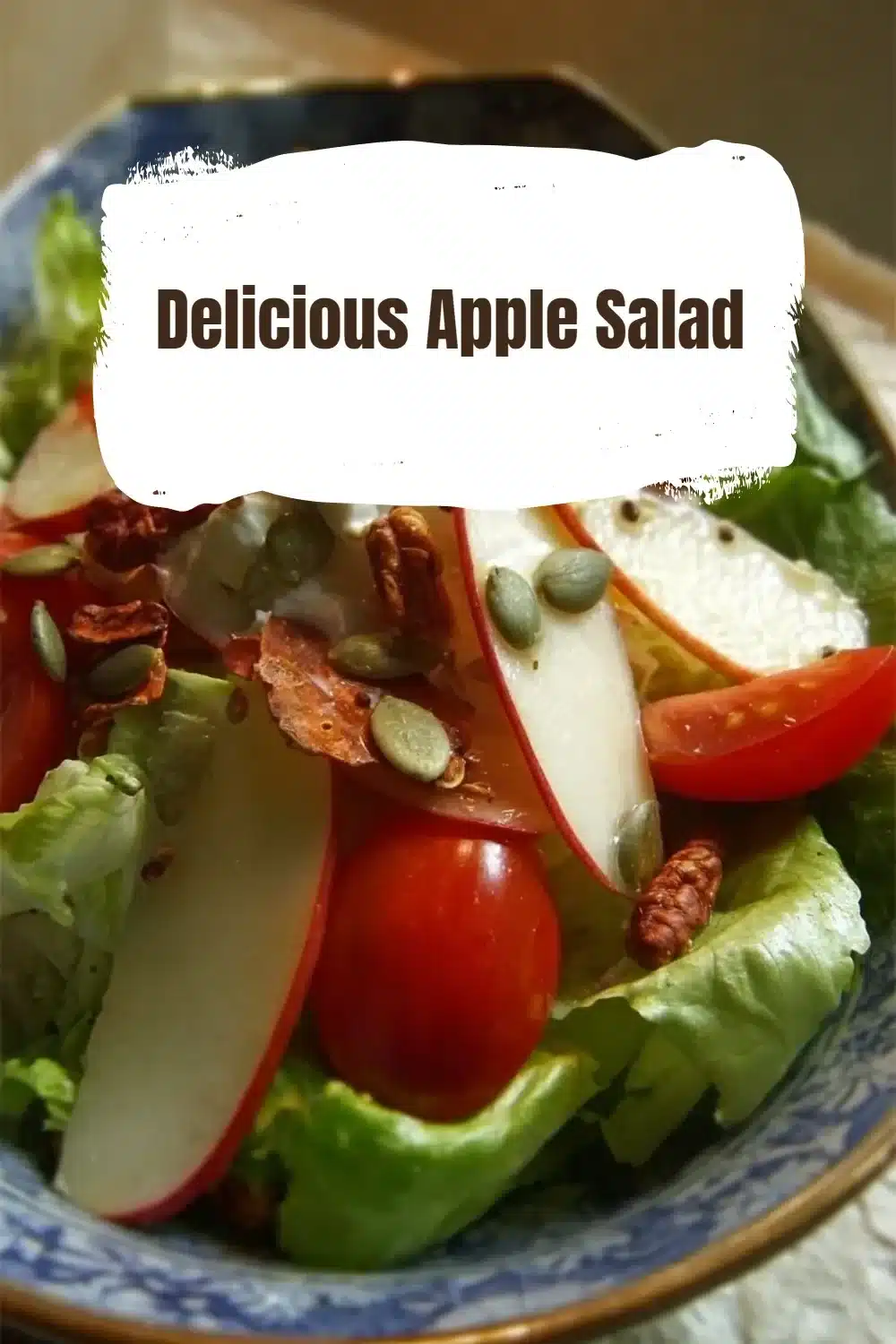 Bowl of delicious apple salad with fresh fruits and nuts topped with dressing