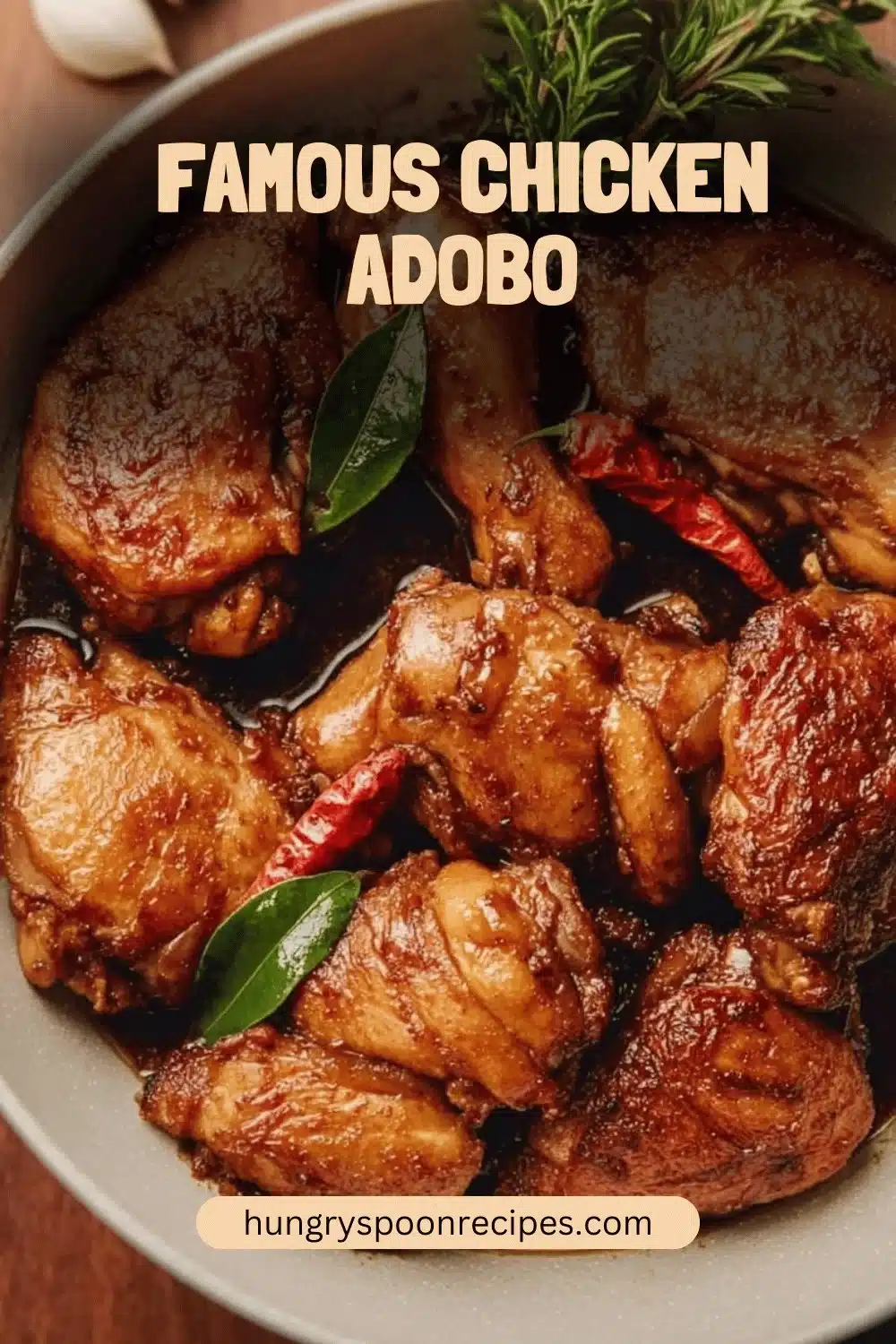 A plate of famous chicken adobo garnished with herbs and served with rice.