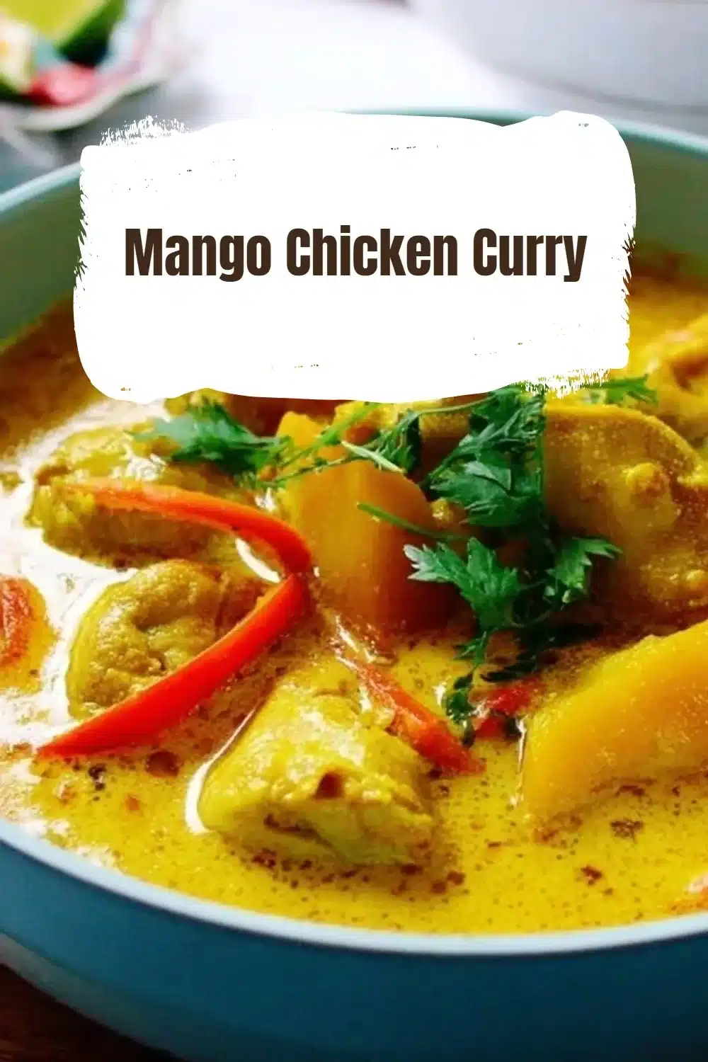 Bowl of delicious Mango Chicken Curry with fresh mango slices and cilantro garnish