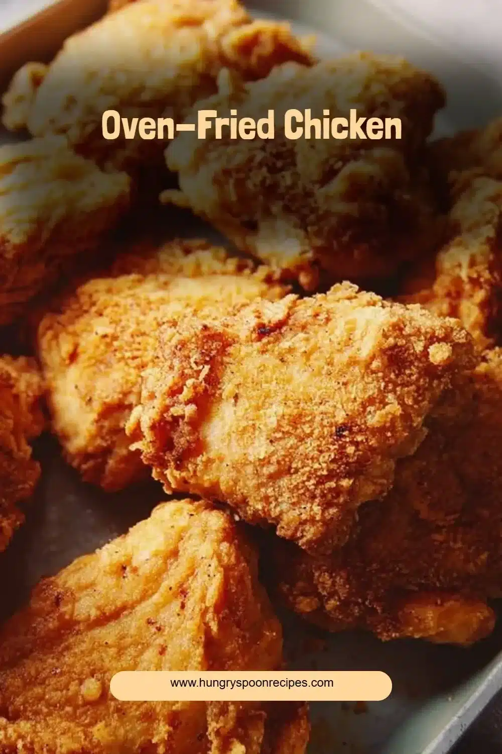 Crispy oven-fried chicken plated with fresh herbs and lemon