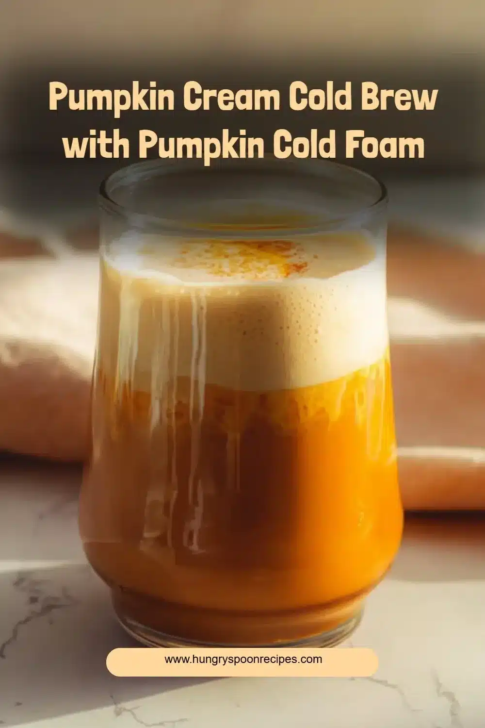 Pumpkin Cream Cold Brew topped with creamy pumpkin cold foam in a glass