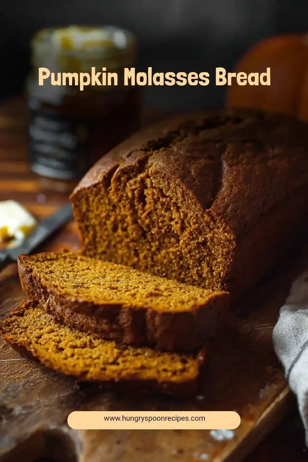 Slice of warm Pumpkin Molasses Bread served on a rustic wooden table