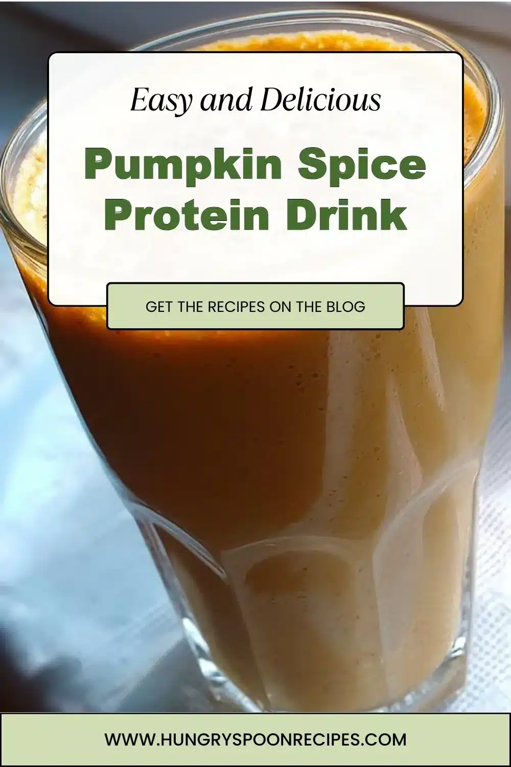 Pumpkin spice protein drink in a cozy autumn setting with spices and a pumpkin.