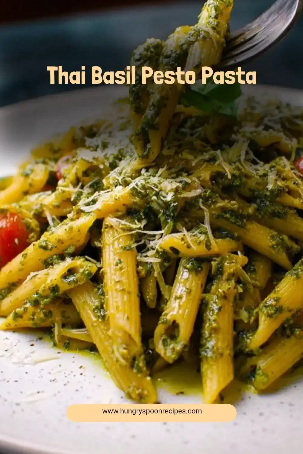 Plate of Thai Basil Pesto Pasta garnished with fresh basil leaves and chili flakes