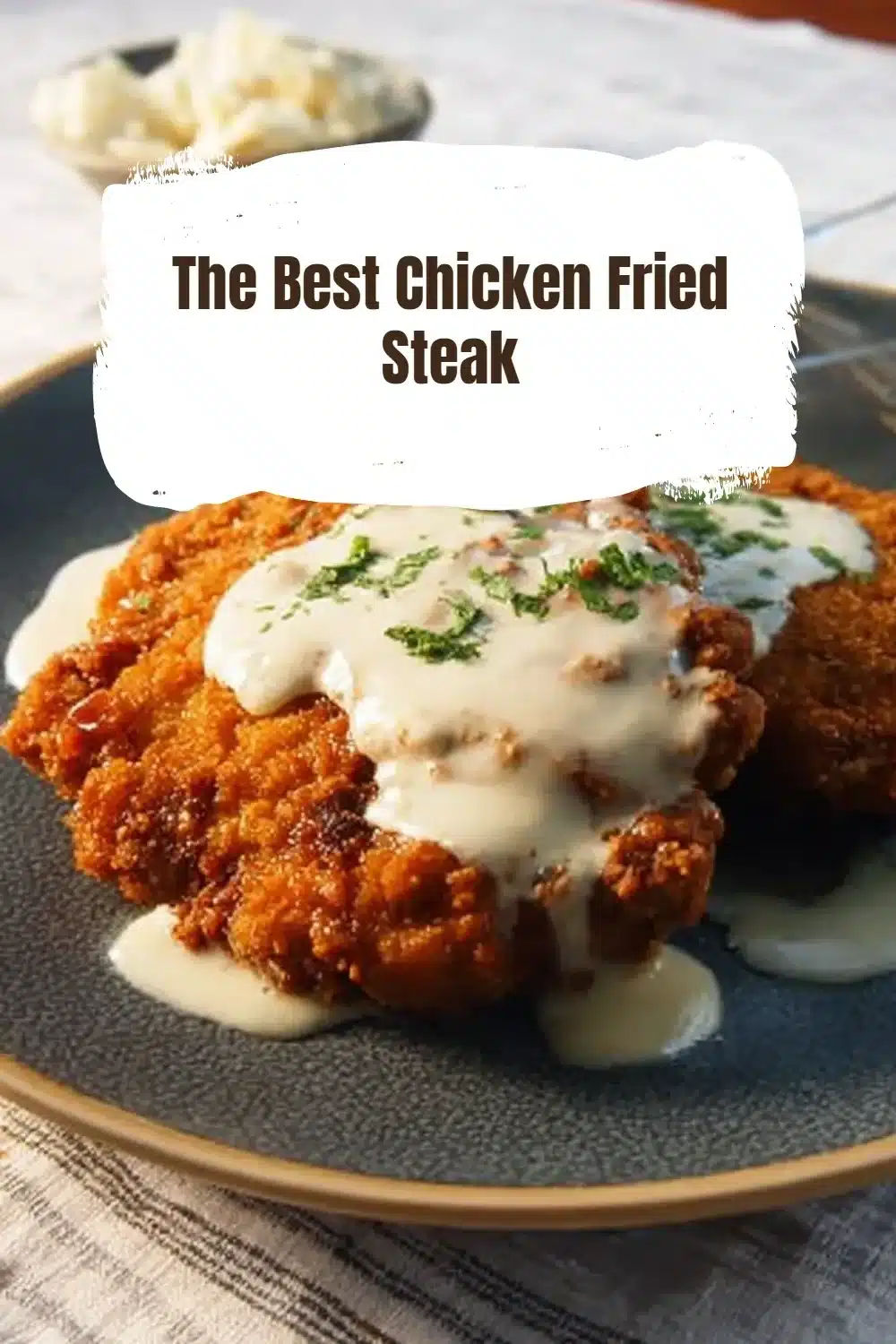 Delicious chicken fried steak topped with creamy gravy on a rustic plate