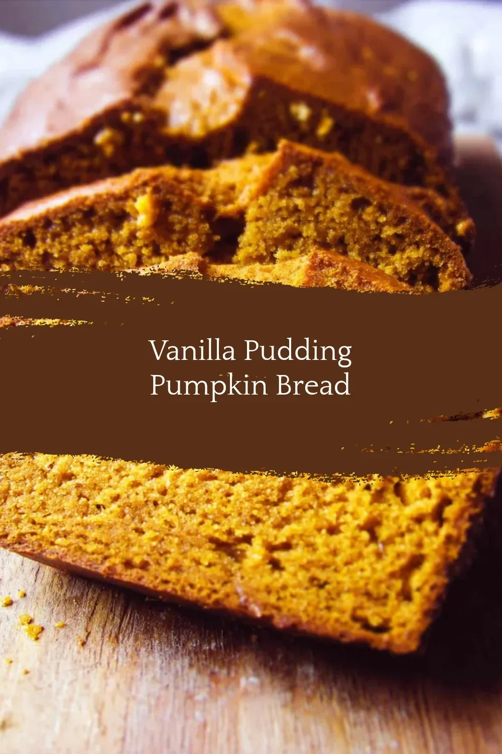 Deliciously moist Vanilla Pudding Pumpkin Bread slice on a wooden table.
