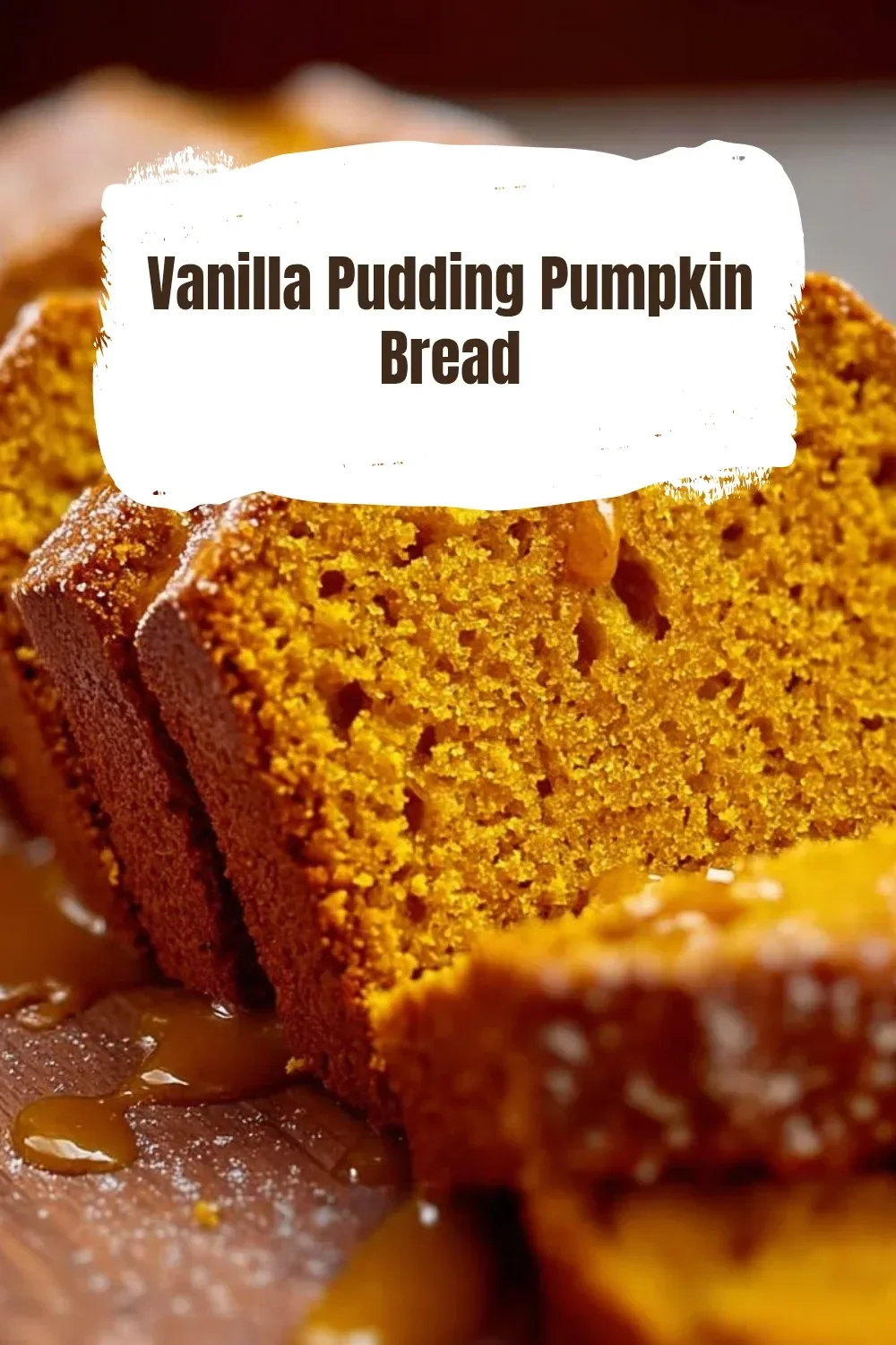 Loaf of Vanilla Pudding Pumpkin Bread on a wooden table with autumn leaves