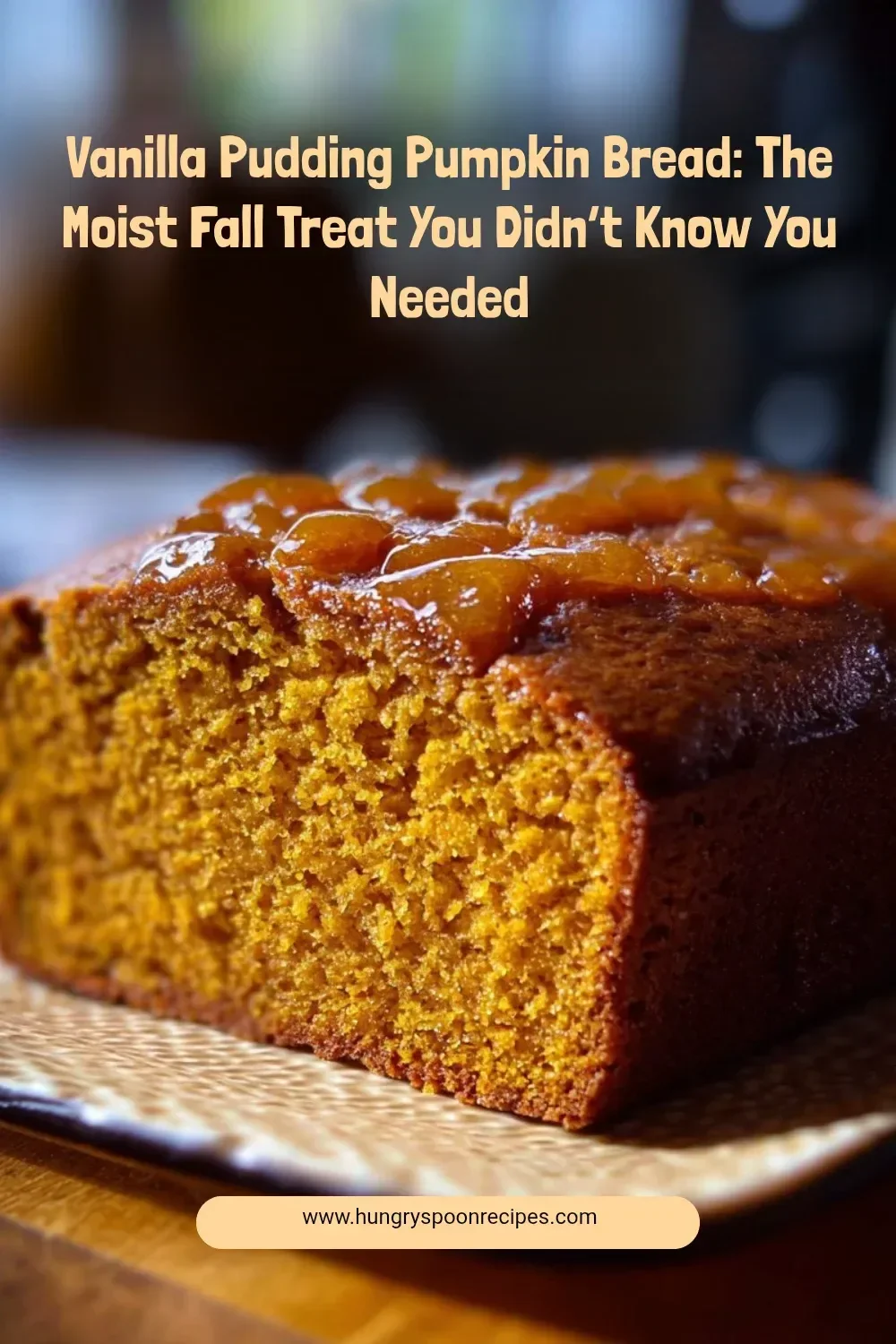 Slice of vanilla pudding pumpkin bread on a wooden board, showcasing its moist texture.