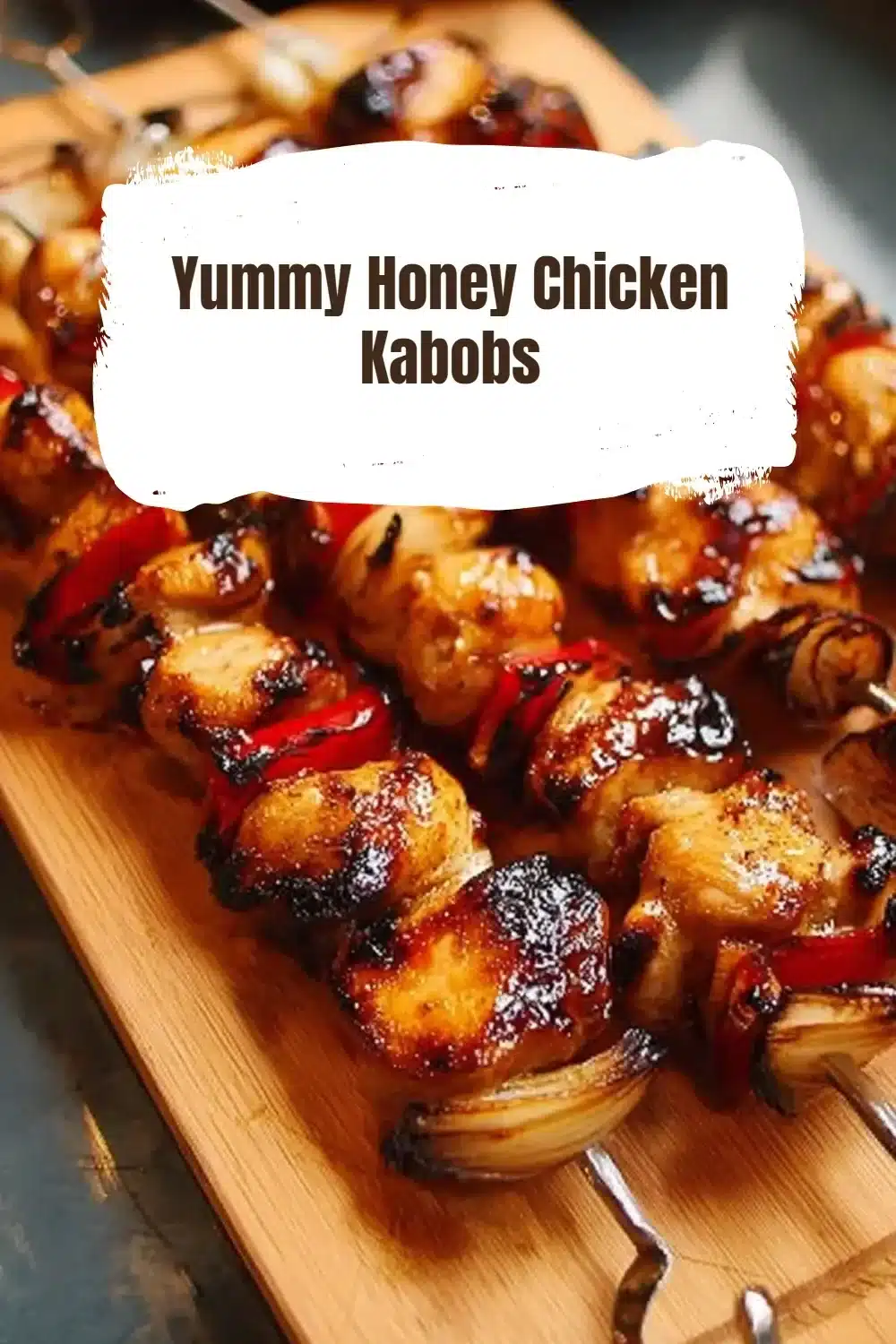 Grilled honey chicken kabobs on a platter garnished with fresh herbs