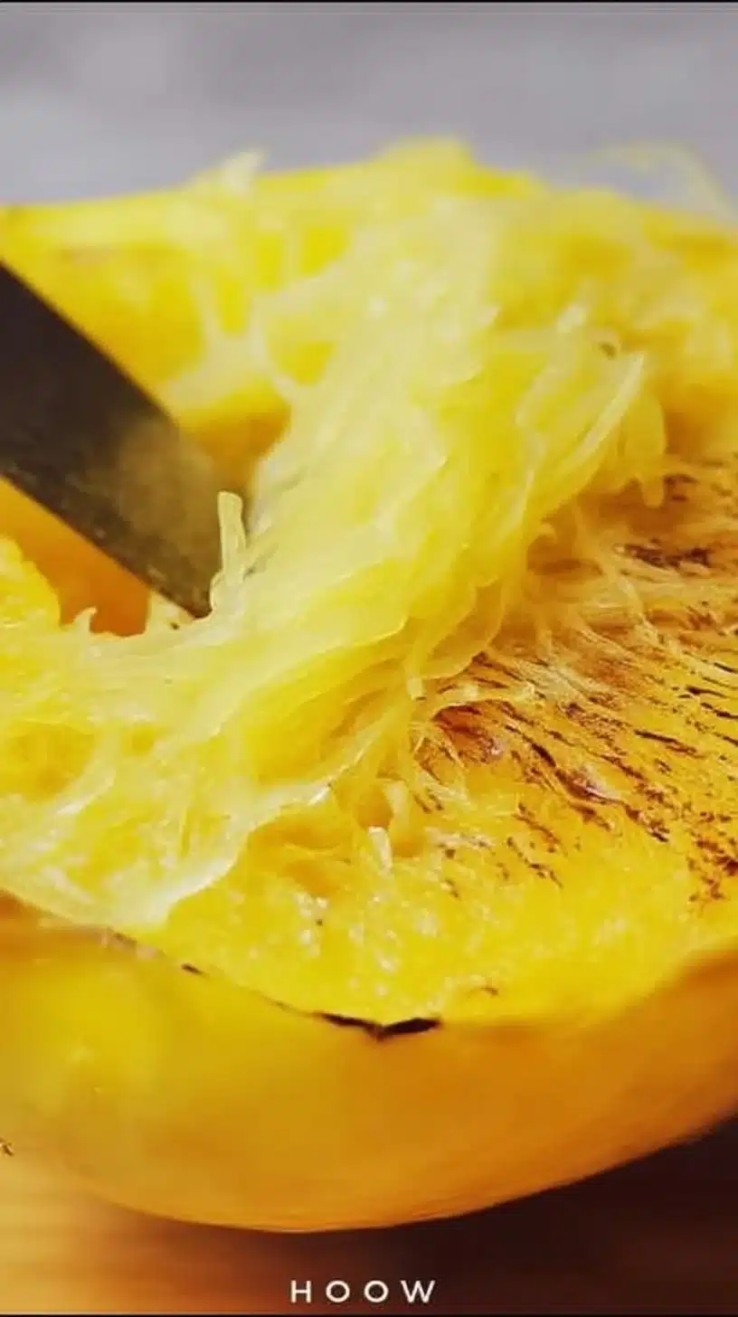 Spaghetti Squash 1 A roasted spaghetti squash cut in half, showcasing its stringy texture and vibrant color.