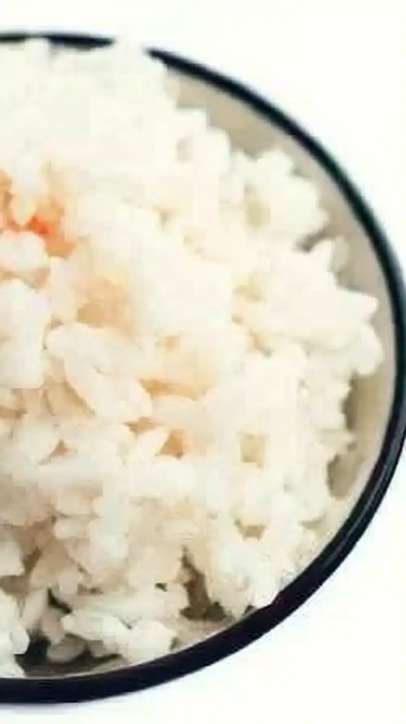 Sushi Rice 1 Bowl of freshly cooked sushi rice with a wooden paddle for sushi preparation.