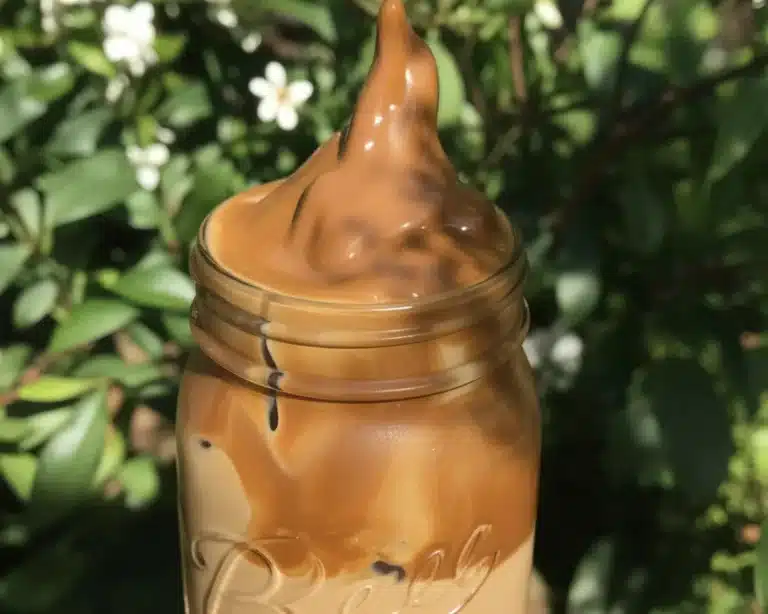 Creamy Dalgona Coffee topped with whipped coffee foam over milk.