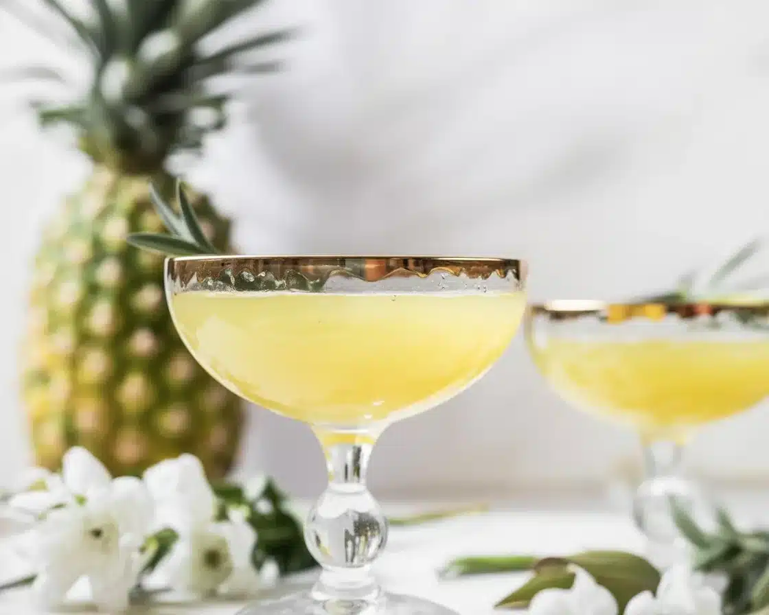 Refreshing Ginger Pineapple Punch for Your Next Get-Together 1 Refreshing Ginger Pineapple Punch served in a glass with fresh fruit garnishes.