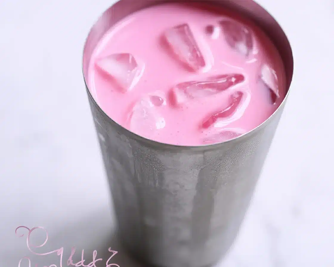 Sip on Bliss: Easy Rose Milk Recipe You’ll Adore 1 Glass of refreshing Rose Milk with homemade rose syrup and rose petals.