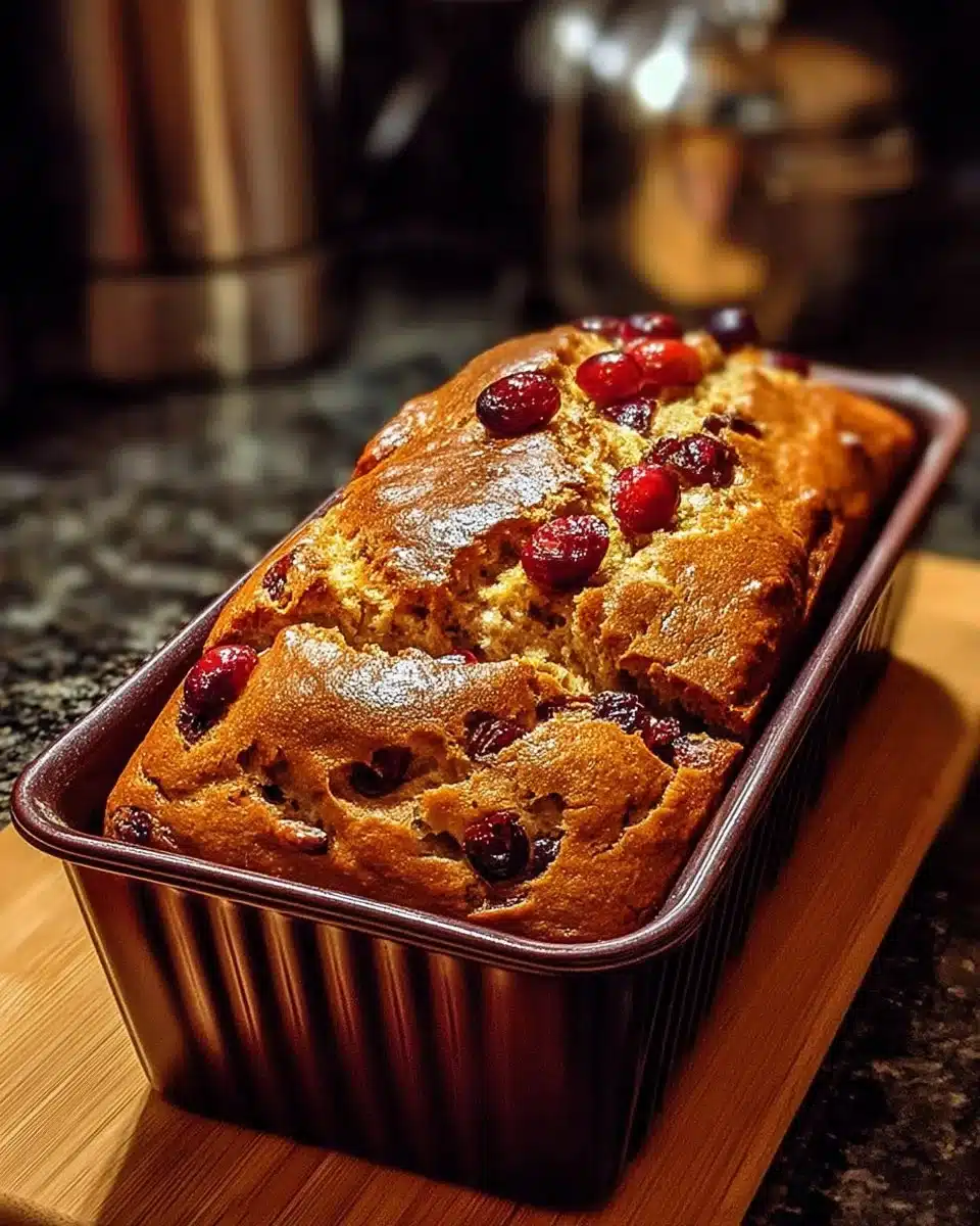 Sliced Ultimate Spiced Cranberry Orange Loaf with cranberries and orange zest